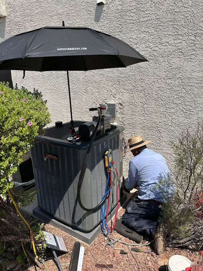 HVAC technician performing outdoor AC maintenance in Iroquois Point