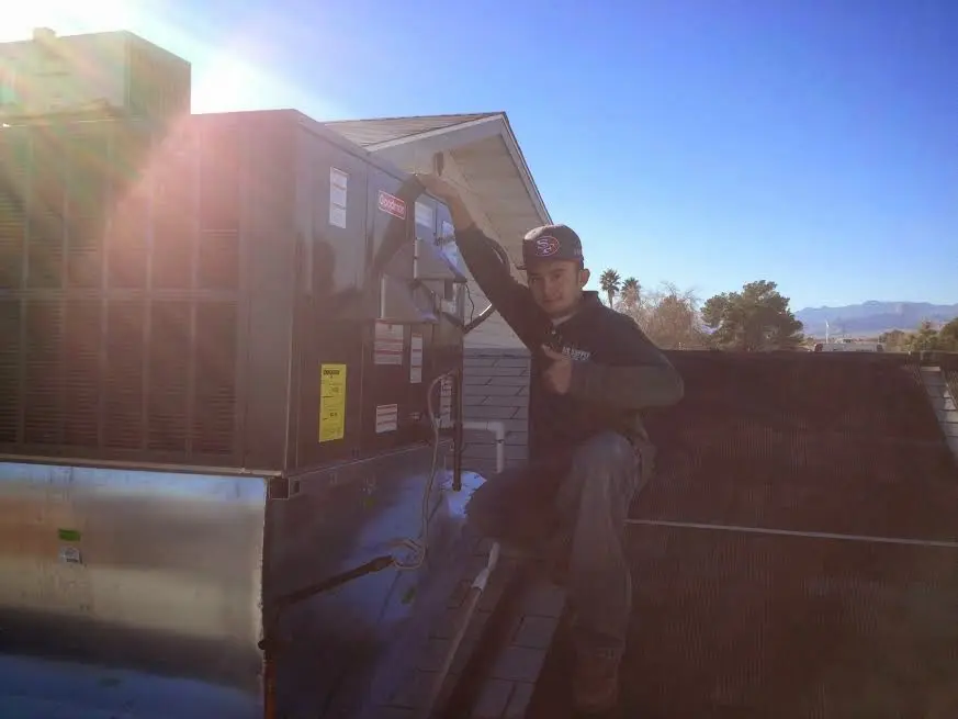 HVAC technician performing HVAC Inspection on a rooftop unit in Iroquois Point